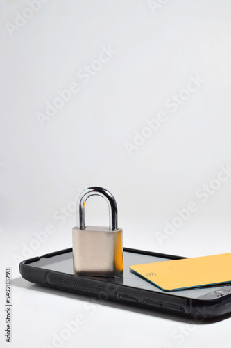 Mobile phone security concept, represented with a padlock, credit card and a broken phone.