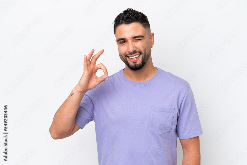 Young Arab handsome man isolated on white background showing ok sign with fingers Young Arab handsome man isolated on white background showing ok sign with fingers