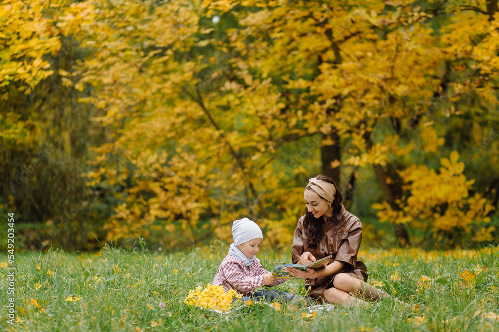 Mom and son walking and having fun together in the autumn park. Mom and son walking and having fun together in the autumn park.