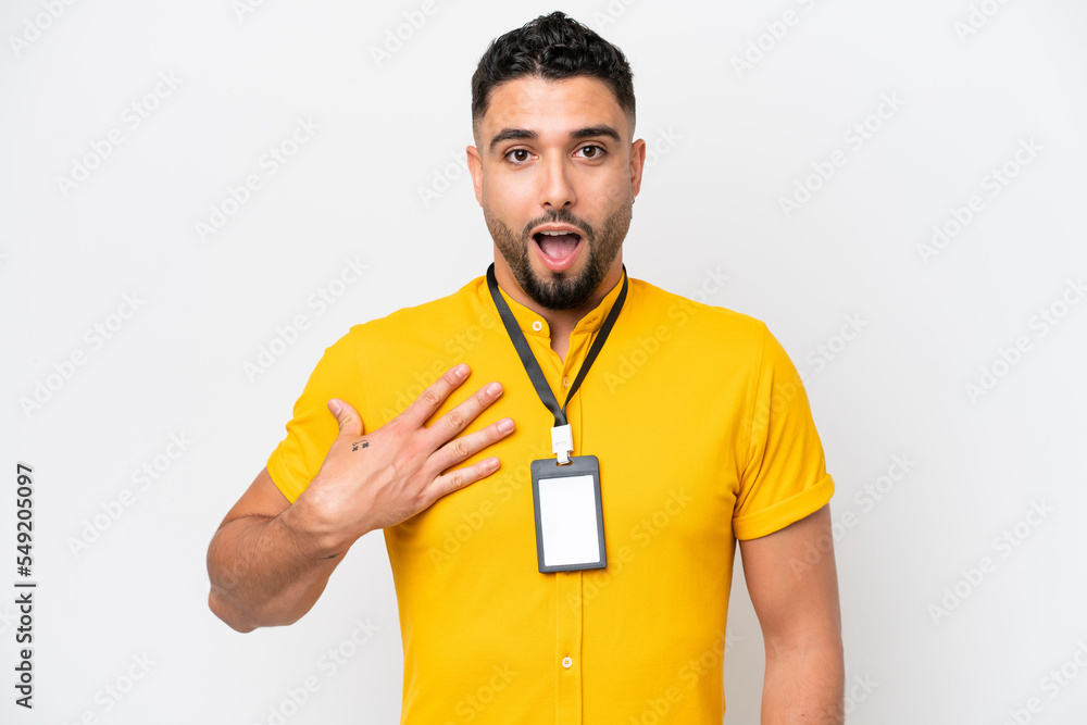 Young Arab man with ID card isolated on white background surprised and shocked while looking right