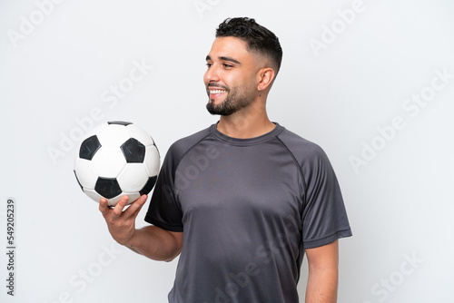 Arab young football player man isolated on white background looking side