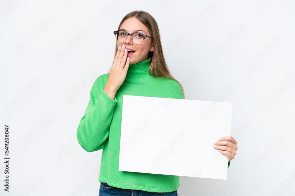 Young caucasian woman isolated on white background holding an empty placard with surprised expression Young caucasian woman isolated on white background holding an empty placard with surprised expression