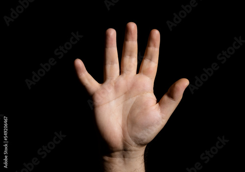 A human hand on a black background