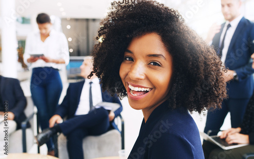 Smile, happy and portrait of black woman at startup meeting for corporate workshop, diversity and networking project. Teamwork, confident and proud afro woman in lounge with men and women in office.