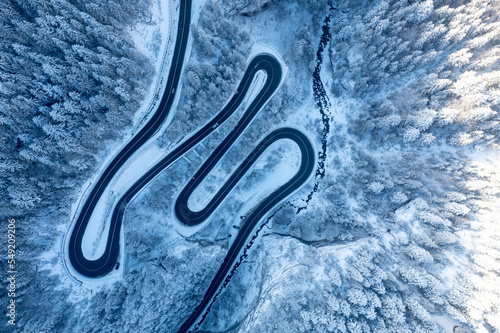 Carpathian, Romania, 2021-12-28. Aerial view of a mountain road under snow. © Alexander