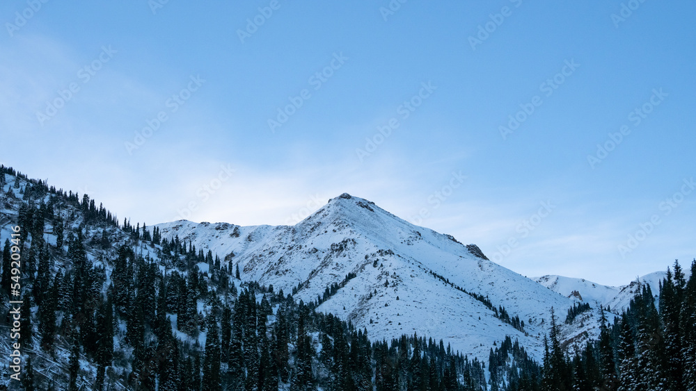 snowy mountains. snowy mountain peaks and cliffs. lonely mountain peak