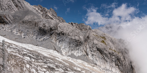 Panorama of snow mountain, glacier and a cloud with blue sky name's Jade Dragon Snow Mountain in Lijiang City, China