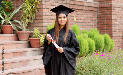 Fotografie Young indian graduated girl holding his graduation degree convocation ceremony