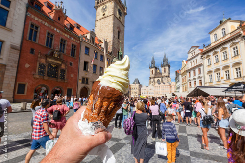 Hand Holding A Trdelnik A Kind Of Spit Cake, Old Town Square On The Background,  Prague, Czech Republic © Davide