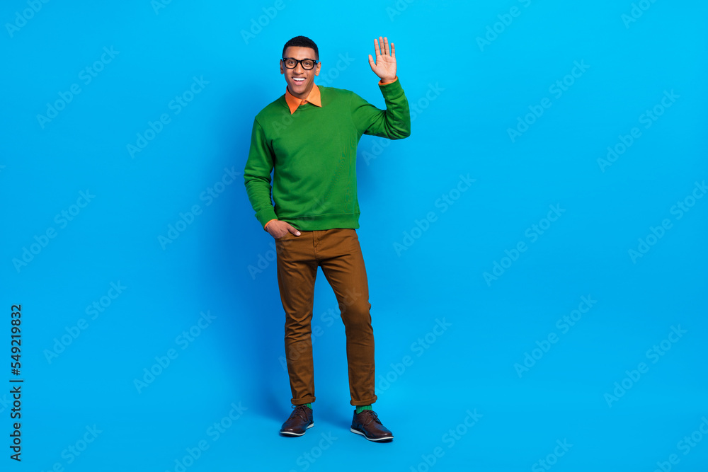 Naklejka premium Full length size photo of satisfied school teacher young guy wear stylish gentleman outfit shake palm hello everybody isolated on blue color background