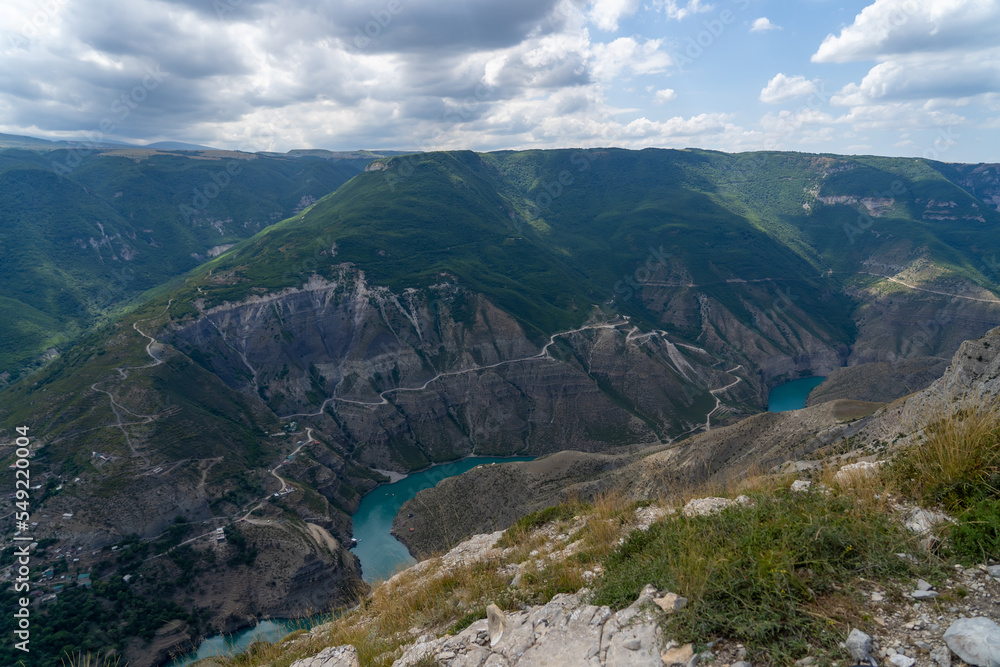 Turquoise river Sulak meandering through rocky forested landscape. Winding turquoise Sulak River in crevice in mountains of Dagestan at summer. Natural canyon in mountains Dubki
