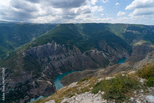 Turquoise river Sulak meandering through rocky forested landscape. Winding turquoise Sulak River in crevice in mountains of Dagestan at summer. Natural canyon in mountains Dubki © sommersby
