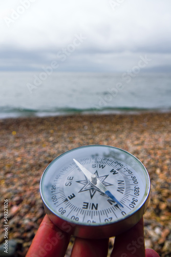 The right compass is always needed for travelers, adequate course. Hiking on the shore of Lake Baikal in Siberia photo