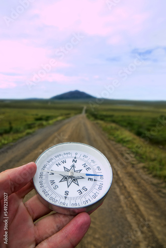 The right compass is always needed for travelers, adequate course. Hiking through the road network of Siberia photo