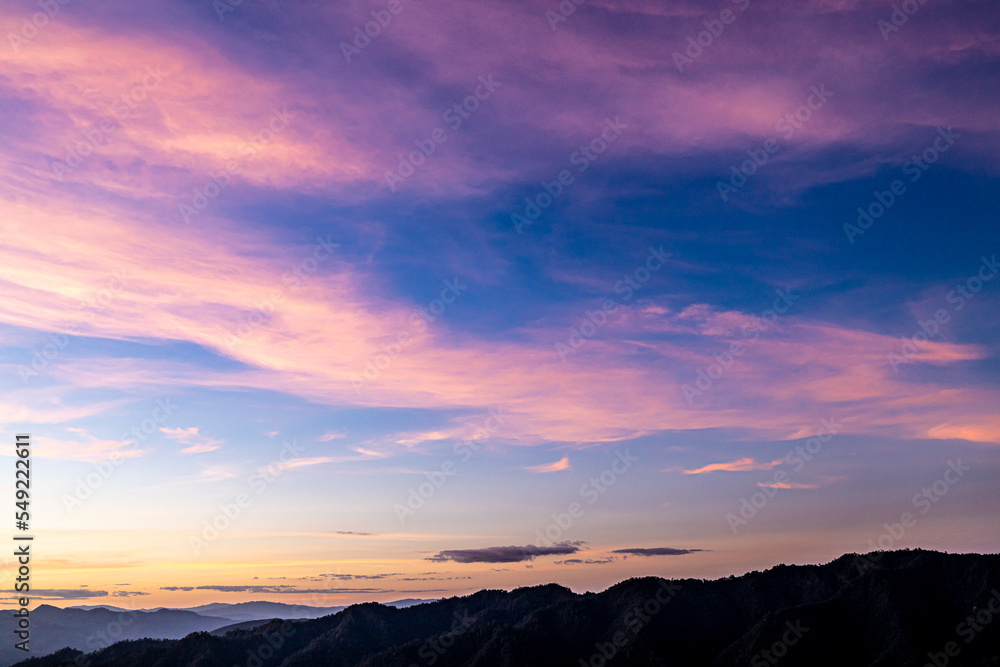Sunset with clouds on the mountains.The sunset gives pass through the clouds late evening. Ray of the sunset with sky background. Beautiful sun beam pass through the cloud. Beautiful sky. Sunset with clouds on the mountains.The sunset gives pass through the clouds late evening. Ray of the sunset with sky background. Beautiful sun beam pass through the cloud. Beautiful sky.