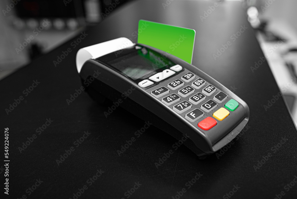 Bank terminal and payment card in the office interior. Bank terminal and payment card in the office interior.