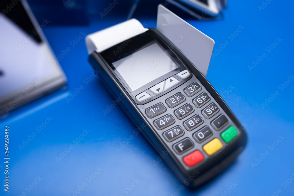 Bank terminal and payment card in the office interior. Bank terminal and payment card in the office interior.
