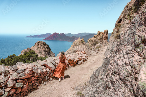 Woman enjoying the views in Corsica of the rocks and the sea. Some unbelievable nature.