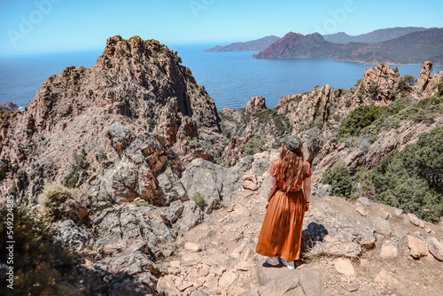 Woman enjoying the views in Corsica of the rocks and the sea. Some unbelievable nature.