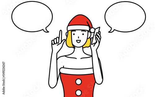 電話をしながら指さしをするサンタクロース姿の女性