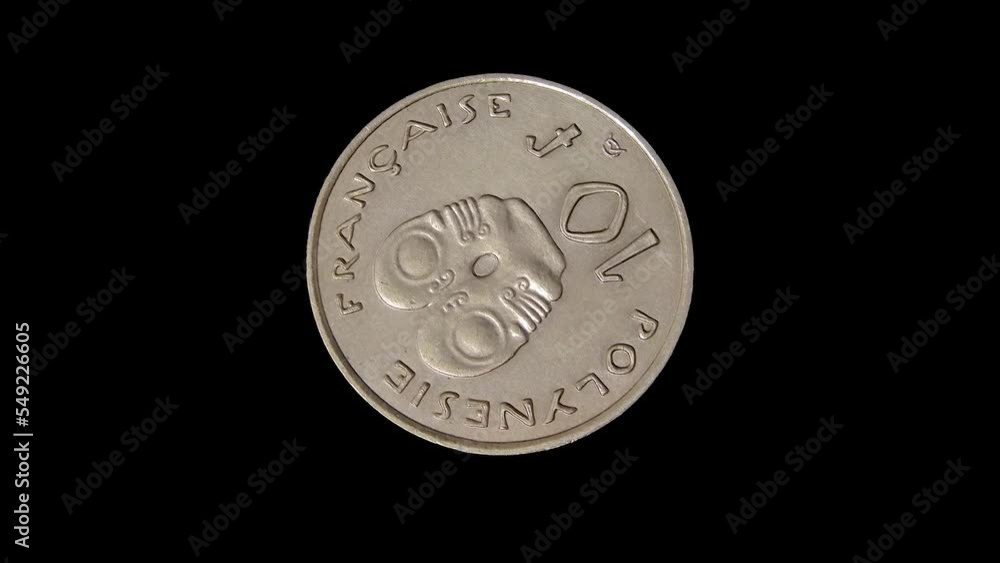 Rotating reverse of French Polynesia coin 10 francs, isolated in black background. Close up view. Rotating reverse of French Polynesia coin 10 francs, isolated in black background. Close up view.