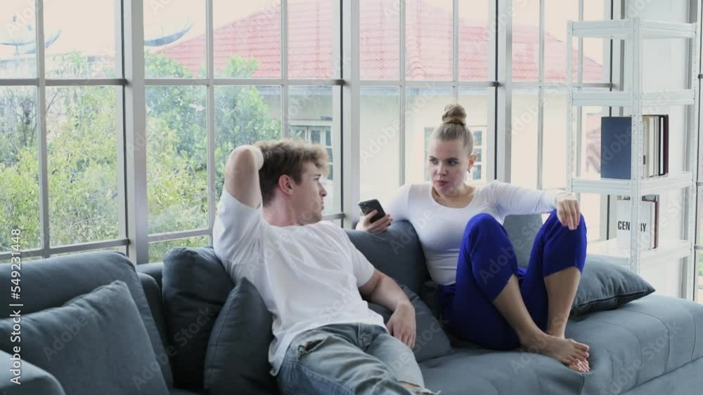 Holiday concept of 4k Resolution. Caucasian couple chatting in the living room. Holiday concept of 4k Resolution. Caucasian couple chatting in the living room.