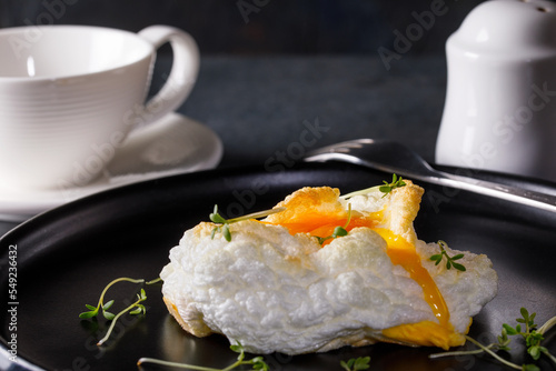 Delicate baked egg. Orsini eggs in the cloud. French breakfast.