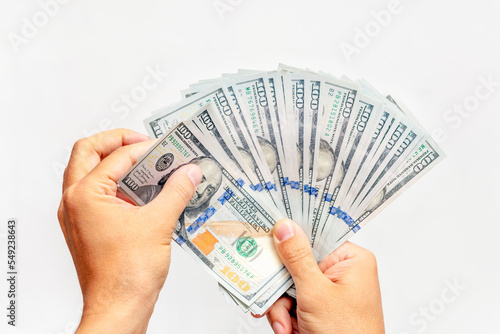 Male's hands counting dollars. US dollar bills fan in hand on white background