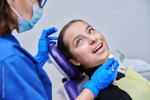 Young teenage female on dental examination treatment in clinic