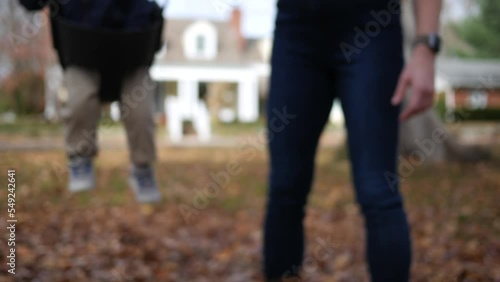 Mother pushes baby in baby swing in residential park