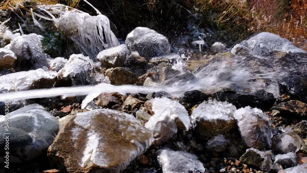 Water flow forms spectacular numerous splashes and glaciation in the riverbed Water flow forms spectacular numerous splashes and glaciation in the riverbed