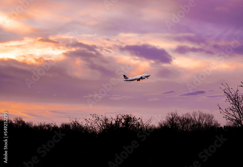 Sunrise silhouetting a plane 