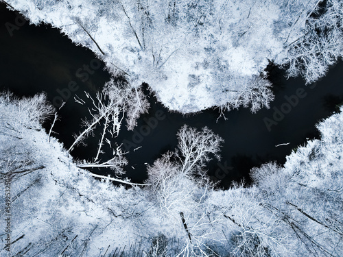 Aerial view of Brda River and snowy forest in winter.
