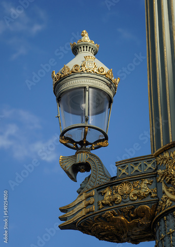 Famous and iconic luxury Parisian street lamp in Concorde Square on the blue sky background.