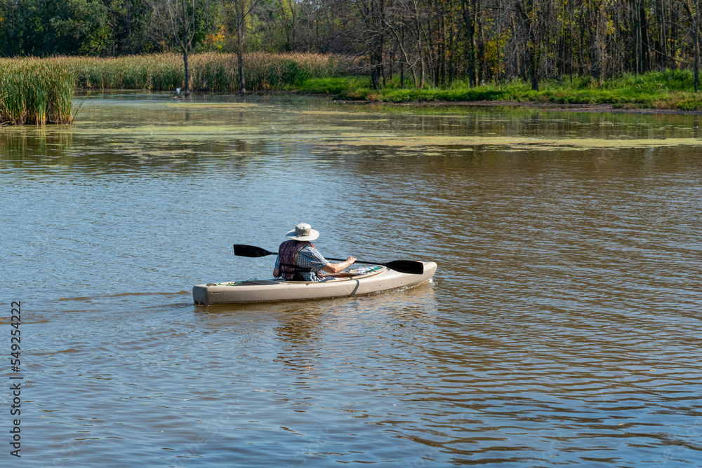 A Person Paddling A Kayak On The River A Person Paddling A Kayak On The River