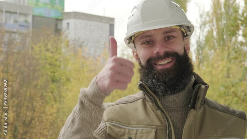 professional happy smiling male worker or builder in helmet showing thumbs up, bearded man in uniform, construction worker, contractor or architect on building site, inspect performance of project professional happy smiling male worker or builder in helmet showing thumbs up, bearded man in uniform, construction worker, contractor or architect on building site, inspect performance of project