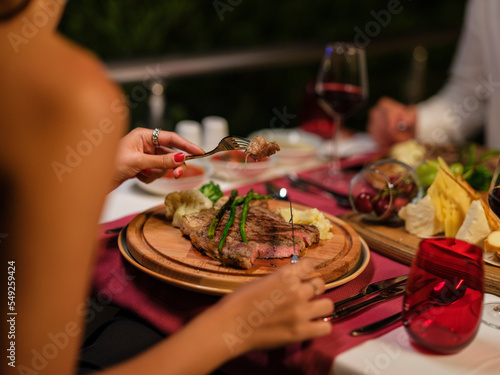 woman eating steak for dinner