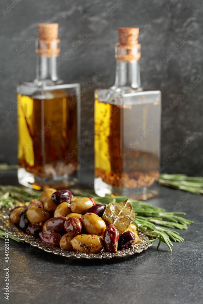 Spicy olives and bottles of olive oil. Spicy olives and bottles of olive oil.