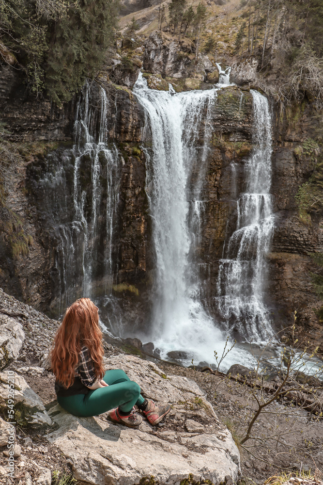 Woman enjoying the beauty of waterfalls. 