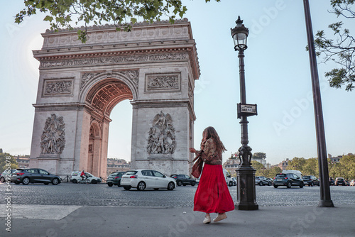 Woman twirling at arc de triomphe.