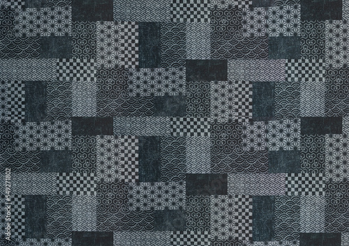 Large texture background of a japanese design patchwork printed on fabric with traditional geometrical shapes depicting various patterns like waves, hemp leaves, tortoise shells or checkered.
