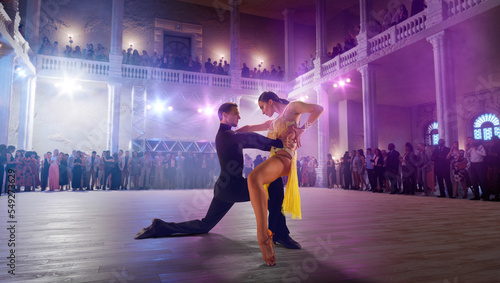 Couple dancers perform latin dance on large professional stage. Ballroom dancing.