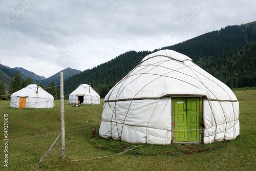 Yurt camp in Karakol Mountains, Tien Shan Mountains, Kyrgyzstan, Central Asia. Traditional nomad's yurts on green mountain meadow in summer.  © Iwona