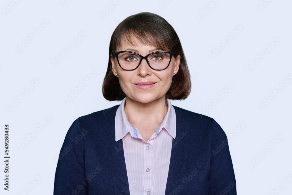 Portrait of business smiling woman looking at camera, white background