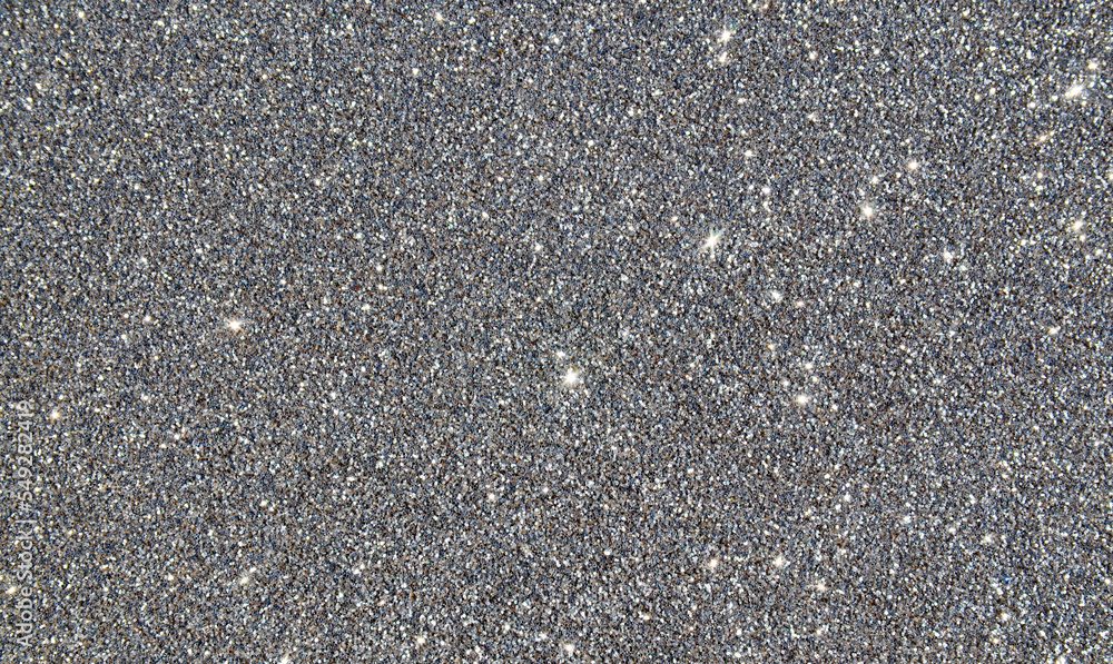 Glitter background in silver colour as a part of Christmas design.Holiday abstract texture with blinking lights.Fabric sequins.Selective focus. Glitter background in silver colour as a part of Christmas design.Holiday abstract texture with blinking lights.Fabric sequins.Selective focus.