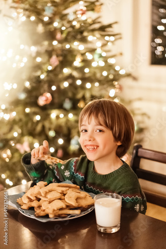Little child eating christmas cookies