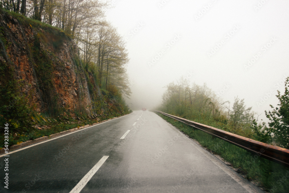 road in the mountains in rainy and foggy weather