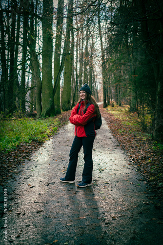 Wallpaper Mural young tourist woman on a trail in an autumnal forest. A single independent courageous and happy woman. Torontodigital.ca