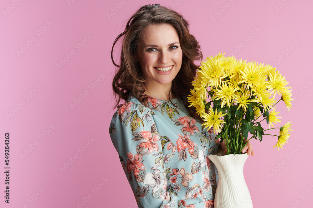 Portrait of happy modern woman in floral dress on pink Portrait of happy modern woman in floral dress on pink
