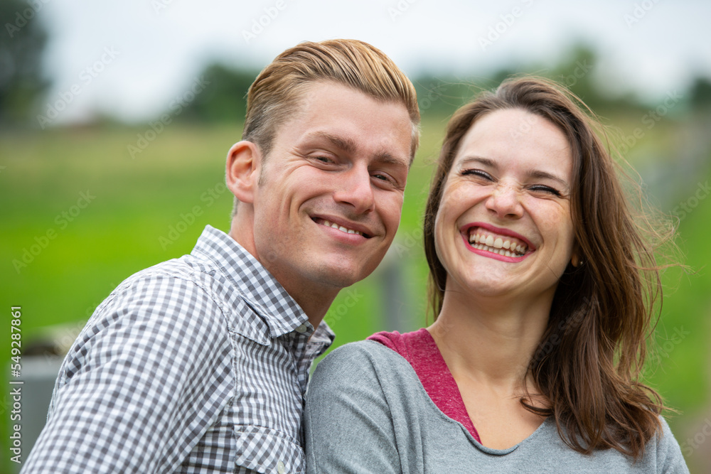 portrait of a young happy laughing couple outside in nature portrait of a young happy laughing couple outside in nature